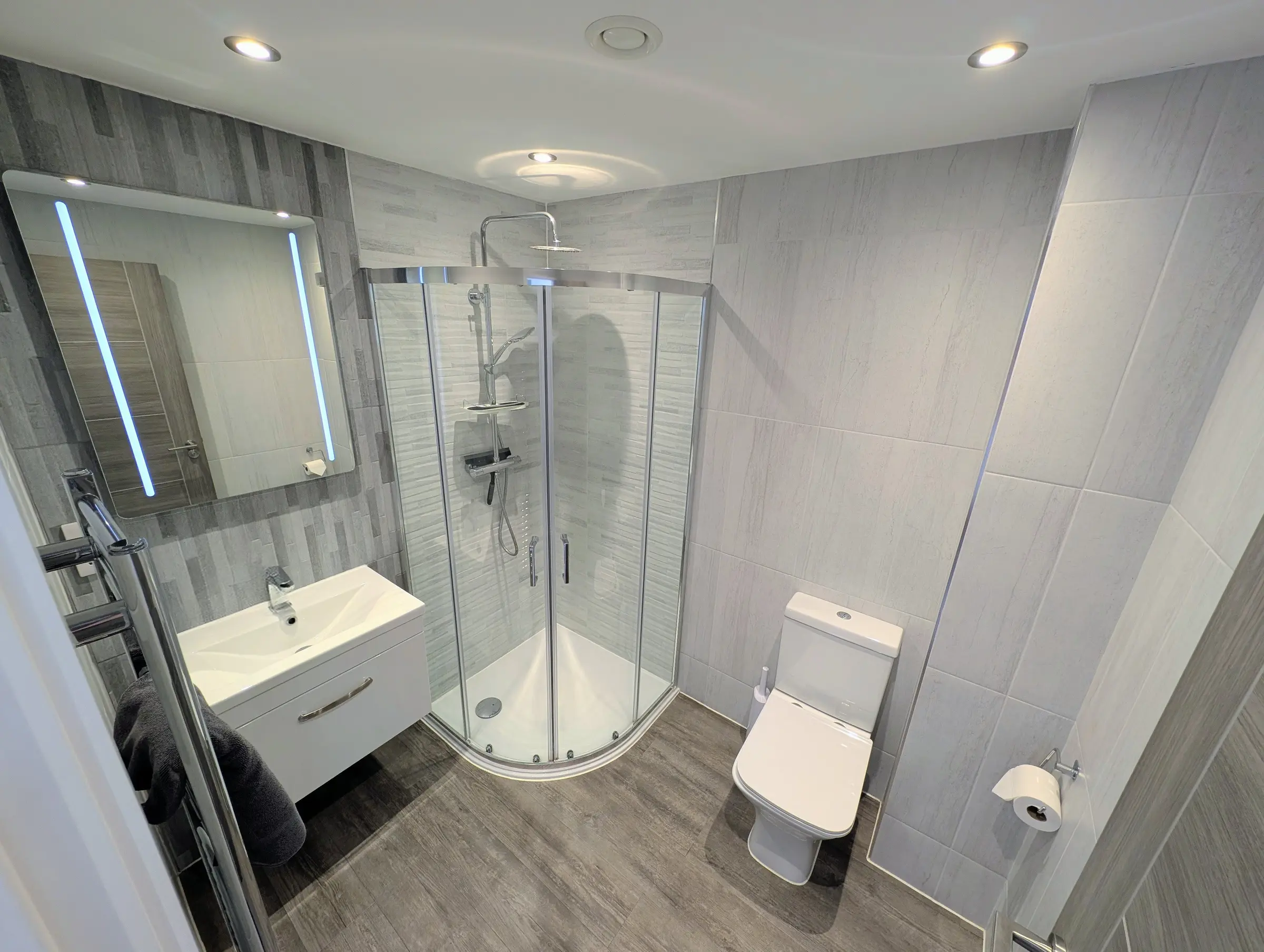 Master bedroom en-suite with curved shower, washbasin and toilet